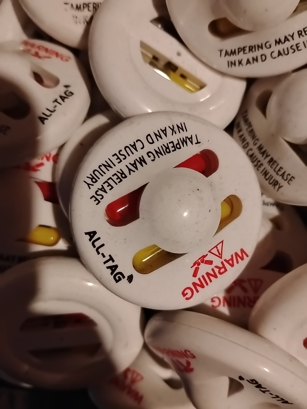 White Retail Security Tag with Red & Yellow Inserts